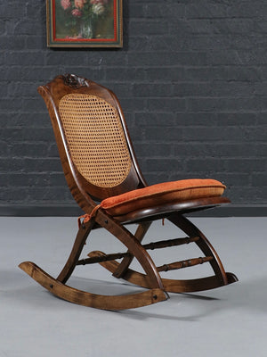 American Victorian Folding Cane Rocking Chair w/ Carved Rose Crest, c.1920's