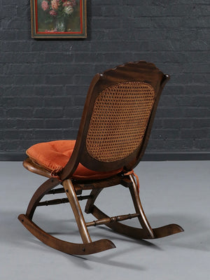 American Victorian Folding Cane Rocking Chair w/ Carved Rose Crest, c.1920's