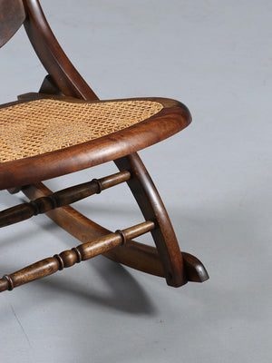 American Victorian Folding Cane Rocking Chair w/ Carved Rose Crest, c.1920's