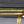 Pair of Hollywood Regency Sculptural Brass & Glass Side Tables, c.1970’s